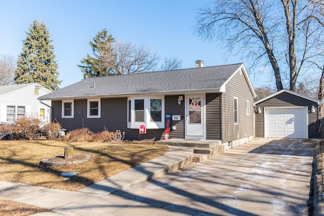 ranch-style house featuring a garage and an outbuilding