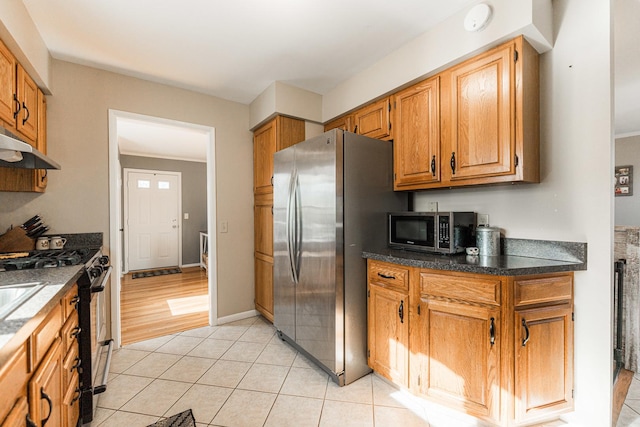 kitchen featuring appliances with stainless steel finishes and light tile patterned floors