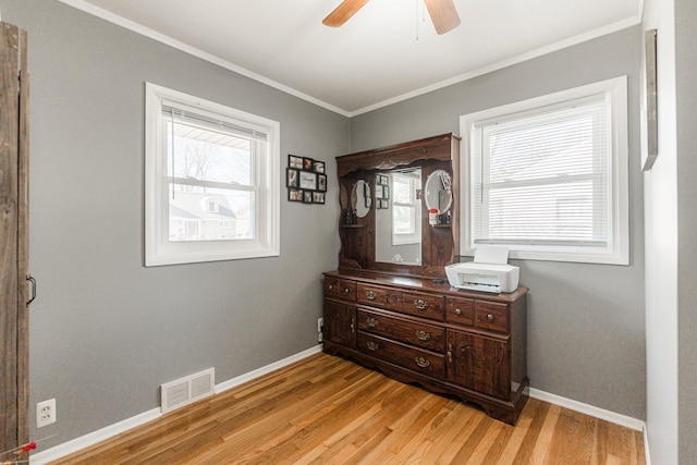 bedroom featuring crown molding, ceiling fan, and light wood-type flooring