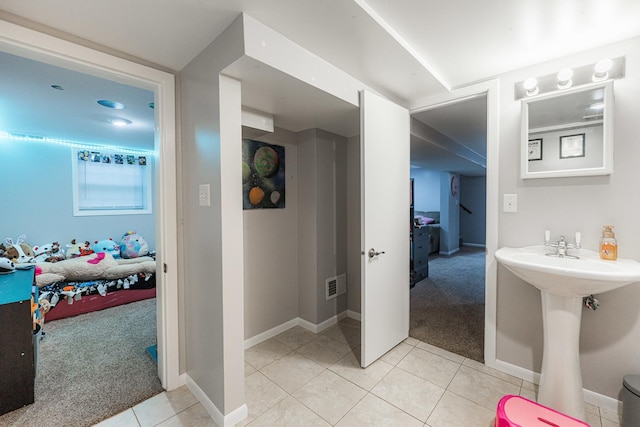 bathroom featuring sink and tile patterned flooring