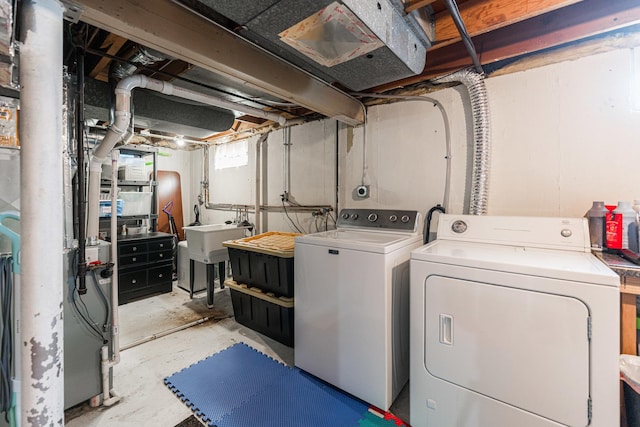 washroom with washer and clothes dryer and sink