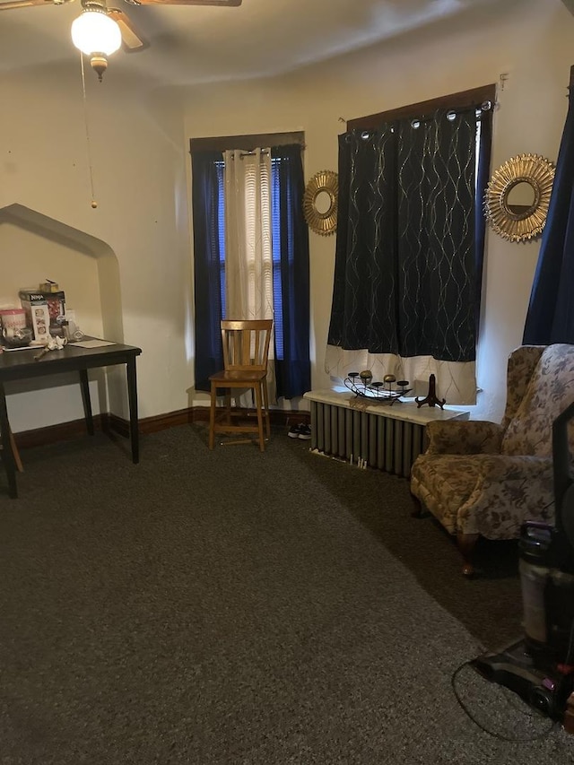 sitting room featuring ceiling fan