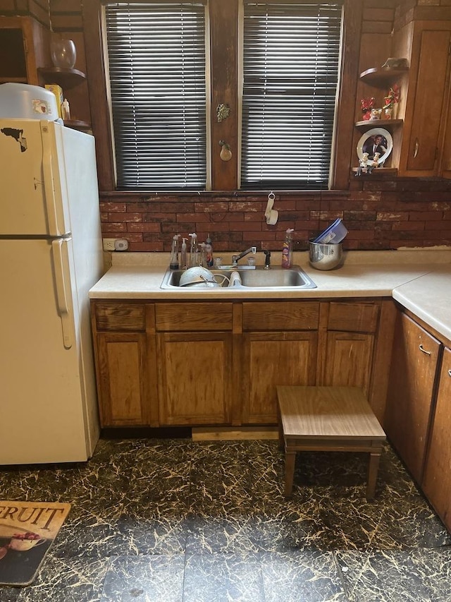 kitchen with sink and white fridge