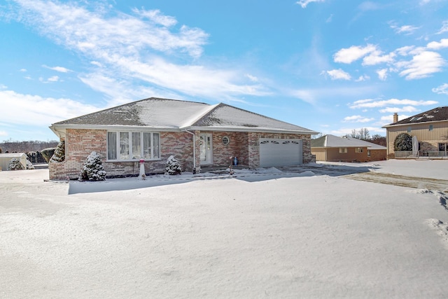 ranch-style house featuring brick siding and an attached garage