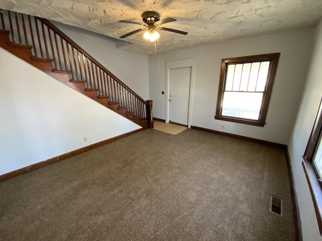 interior space featuring a textured ceiling and ceiling fan