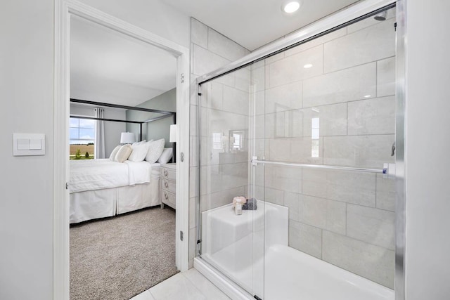 bathroom with an enclosed shower and tile patterned floors