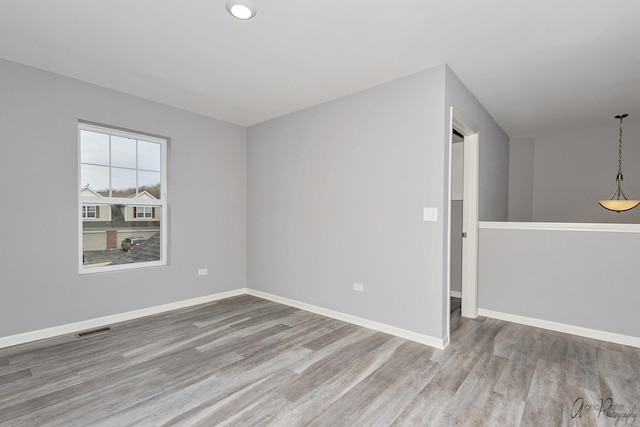 spare room featuring light hardwood / wood-style flooring