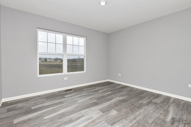 unfurnished room with hardwood / wood-style floors