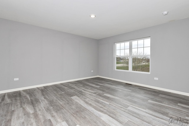 spare room with hardwood / wood-style floors