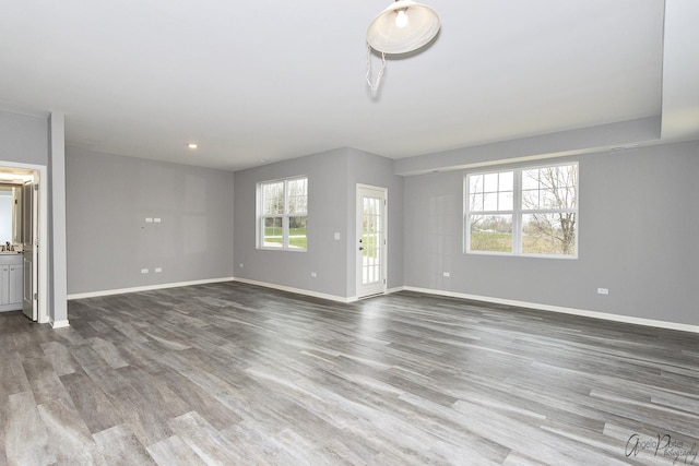 unfurnished living room with hardwood / wood-style flooring