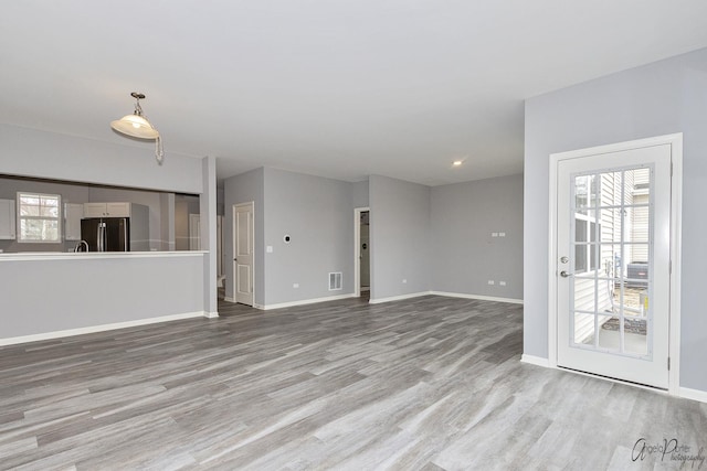 unfurnished living room with light hardwood / wood-style flooring