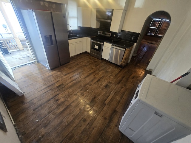 kitchen with white cabinetry, appliances with stainless steel finishes, sink, and dark wood-type flooring