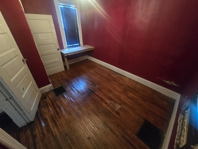 unfurnished bedroom with dark hardwood / wood-style floors