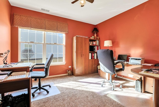 carpeted office space with ceiling fan