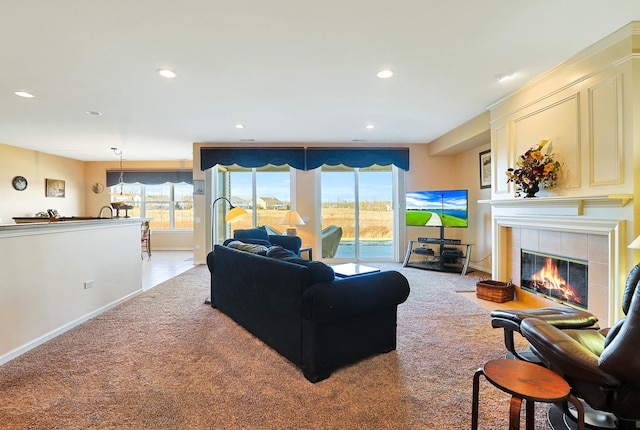 carpeted living room with a healthy amount of sunlight and a fireplace