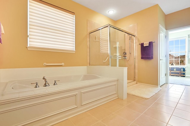 bathroom with separate shower and tub and tile patterned flooring