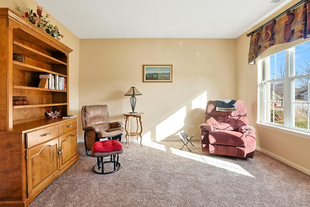 living area featuring light carpet