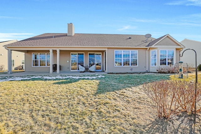 rear view of house with a patio area and a lawn