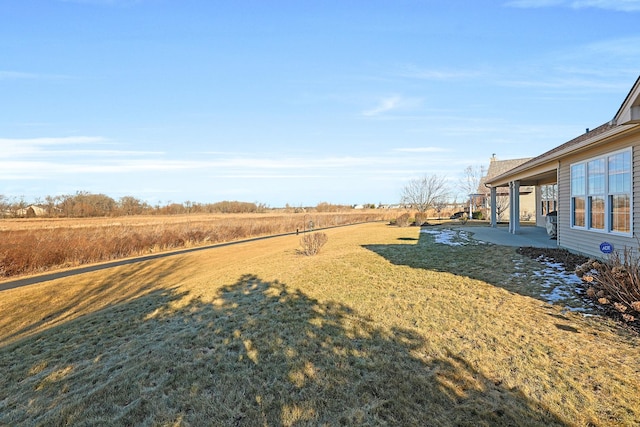 view of yard featuring a patio and a rural view