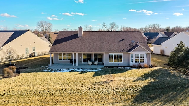 rear view of property featuring a yard and a patio