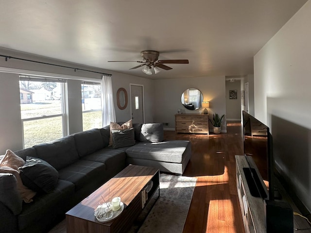 living room featuring dark hardwood / wood-style flooring and ceiling fan