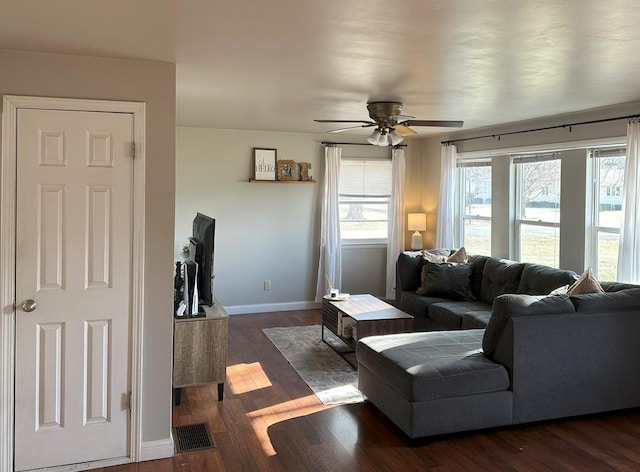 living room with ceiling fan, a healthy amount of sunlight, and dark hardwood / wood-style floors