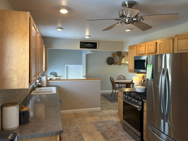 kitchen with sink, ceiling fan, and appliances with stainless steel finishes