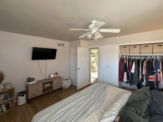 bedroom featuring dark wood-type flooring, ceiling fan, and a closet