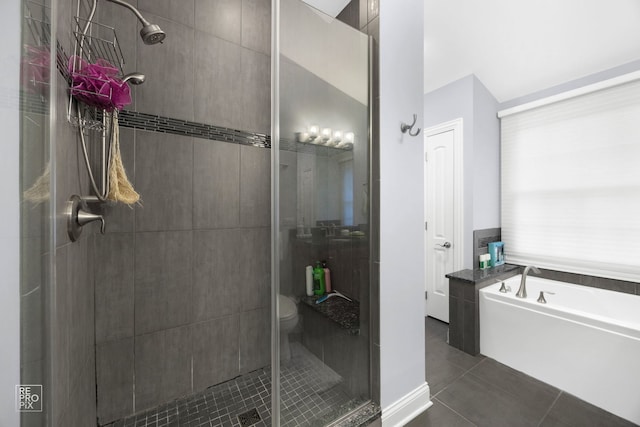 bathroom with shower with separate bathtub, tile patterned floors, and toilet