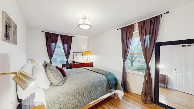 bedroom featuring light wood-type flooring and multiple windows