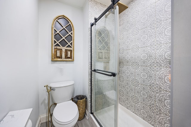 bathroom featuring toilet and walk in shower