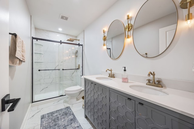 bathroom featuring vanity, toilet, and a shower with door