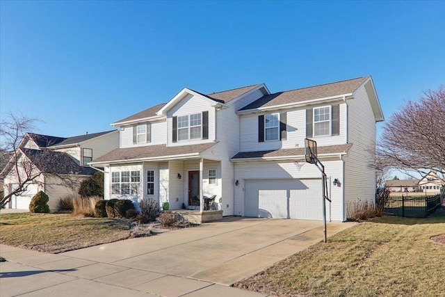 view of property with a garage and a front lawn