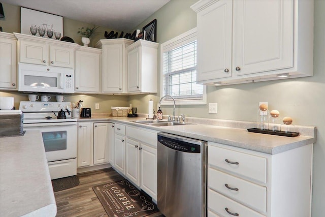 kitchen featuring white cabinetry, white appliances, dark wood-type flooring, and sink