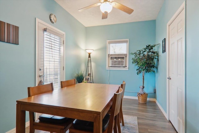 dining room featuring cooling unit, ceiling fan, and dark wood-type flooring