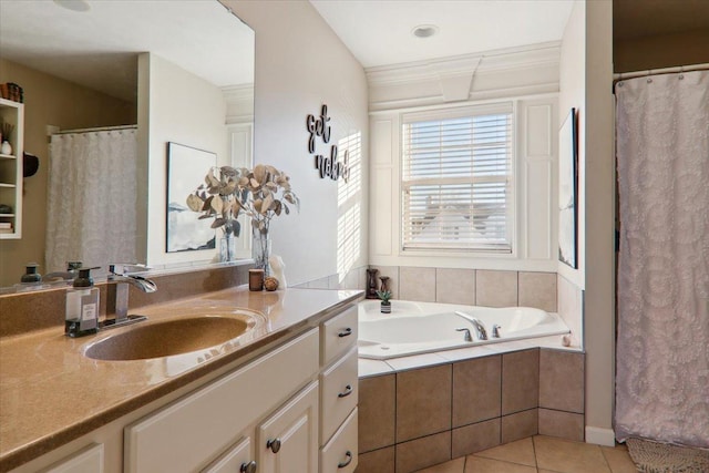 bathroom featuring tile patterned flooring, vanity, and tiled bath