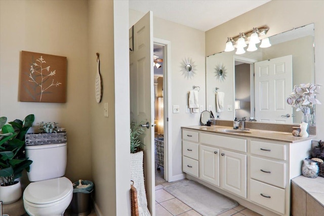 bathroom with vanity, tile patterned floors, and toilet