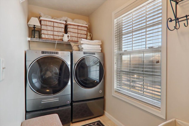 washroom featuring independent washer and dryer and light tile patterned floors