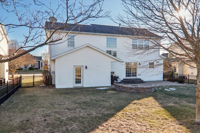 back of house with a lawn and a patio