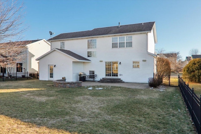 back of house featuring a patio and a yard