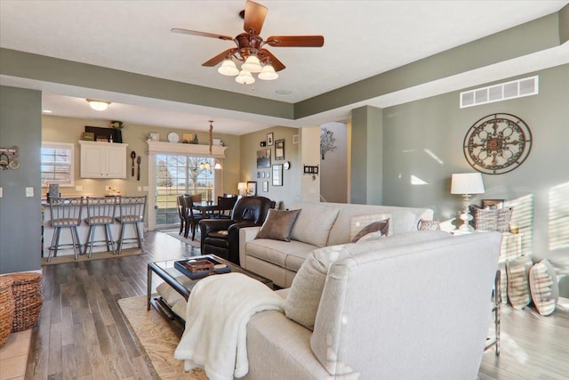 living room featuring hardwood / wood-style flooring and ceiling fan