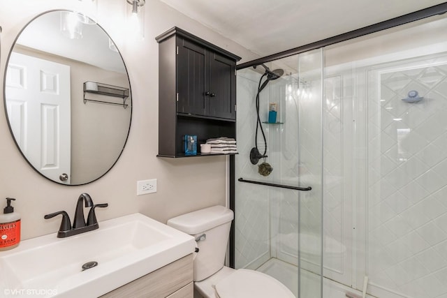 bathroom with walk in shower, vanity, and toilet