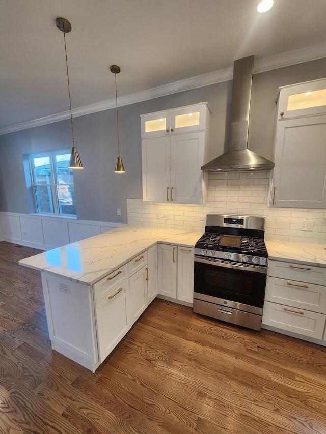 kitchen with white cabinetry, stainless steel range with gas stovetop, wall chimney range hood, and kitchen peninsula