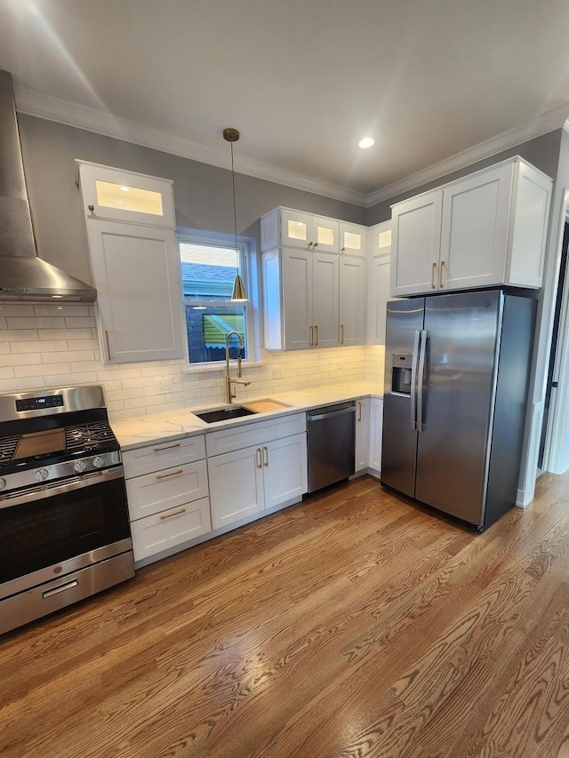 kitchen with white cabinetry, stainless steel appliances, and range hood