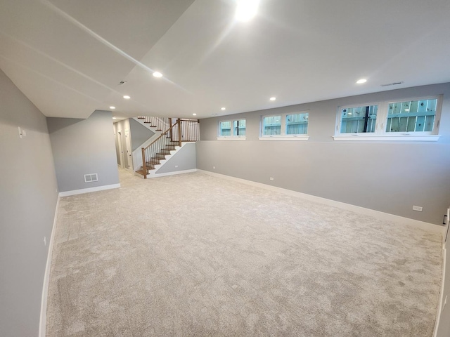 basement featuring light carpet