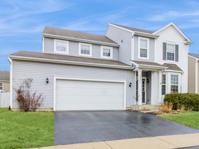 view of front of property with a garage and a front yard