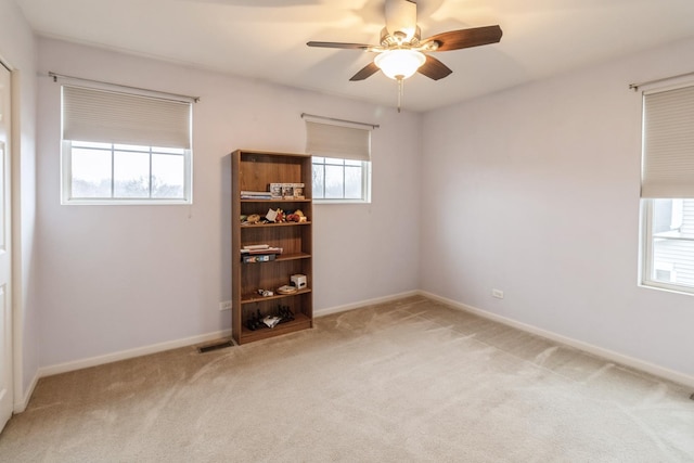 empty room featuring carpet floors and ceiling fan