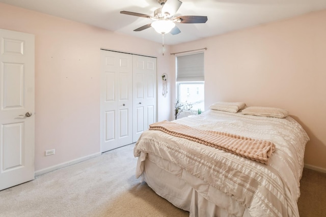 bedroom with light carpet, a closet, and ceiling fan