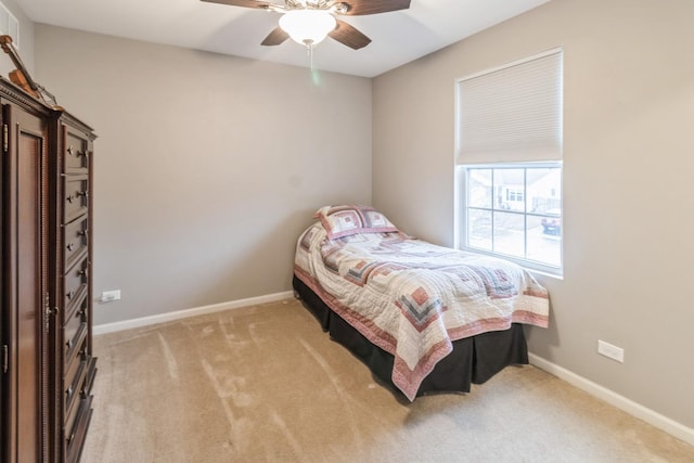 bedroom featuring light colored carpet and ceiling fan