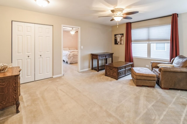 sitting room featuring ceiling fan and light colored carpet